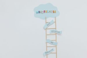 Creative mindfulness concept with ladder, words, and cloud shape for mental well